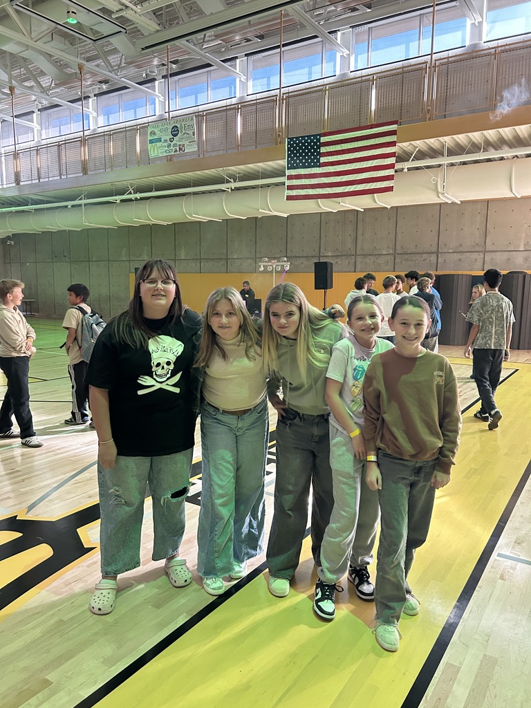 Girls posing at the dance at the gym