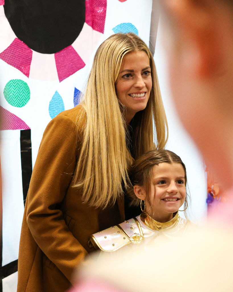A parent and student smile as they pose in front of a sugar skull during an ofrenda event at Canyon Creek Elementary.
