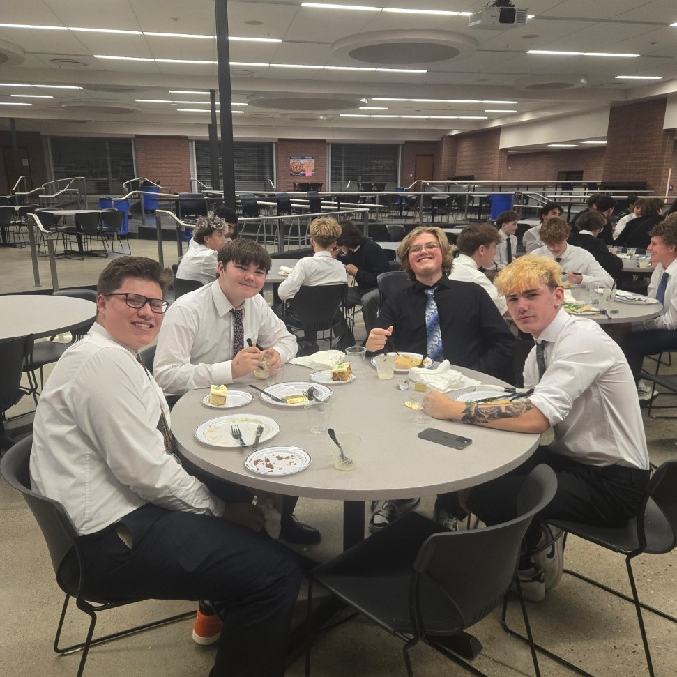 wrestlers posing for a picture at dinner