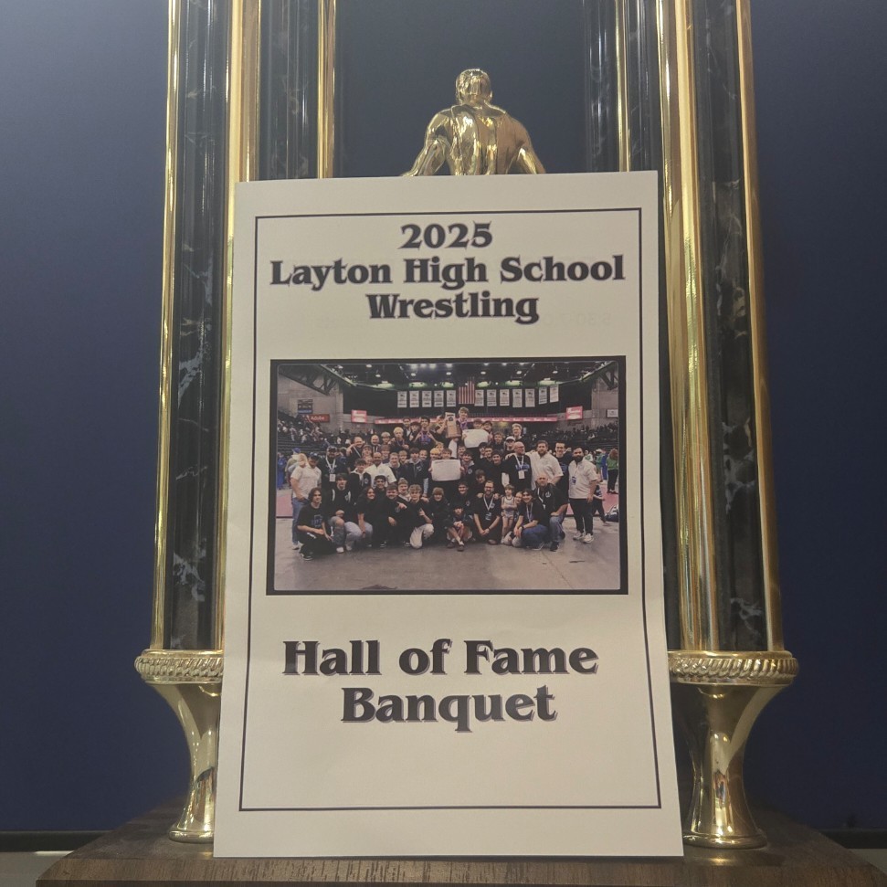 trophy and program showing 2025 Layton High School Wrestling Hall of Fame Banquet