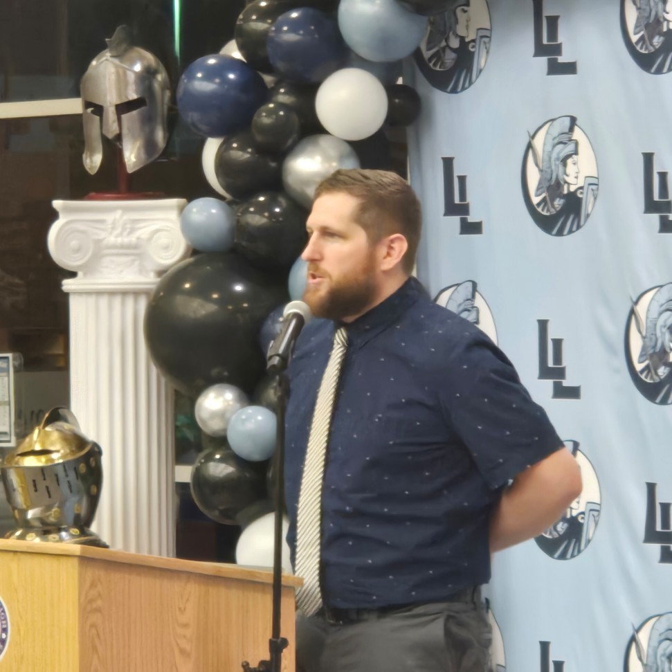 Coach Adam Fager addressing the audience