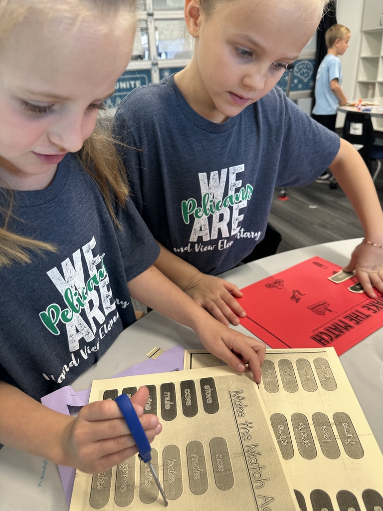boy and girl using scissors and looking at making a match paper