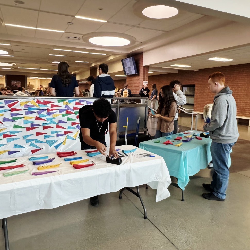 students filling out colored pennants for the schools they applied to