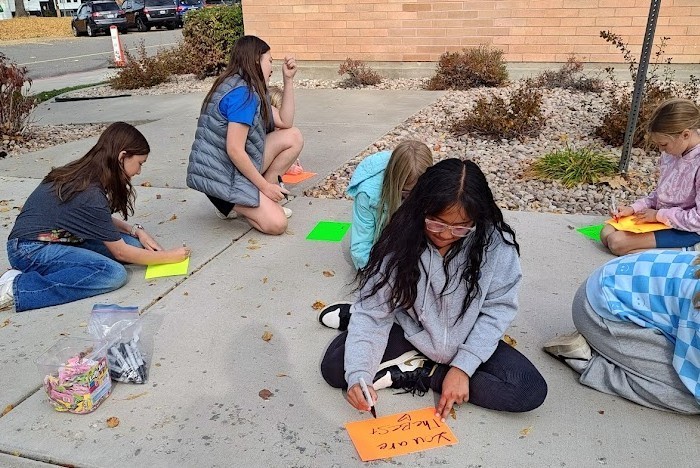 Students writing kind notes.