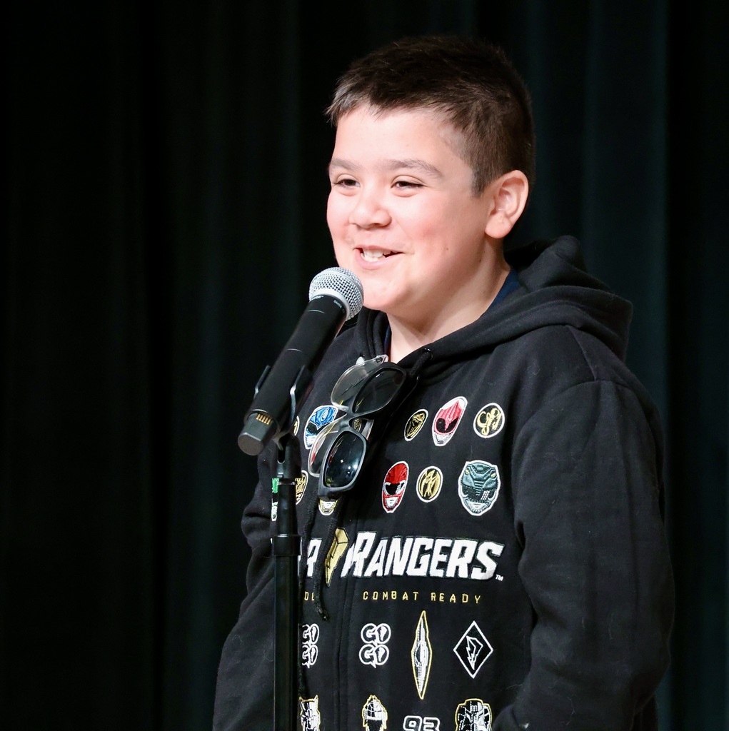 A student talks in front of a mic. 