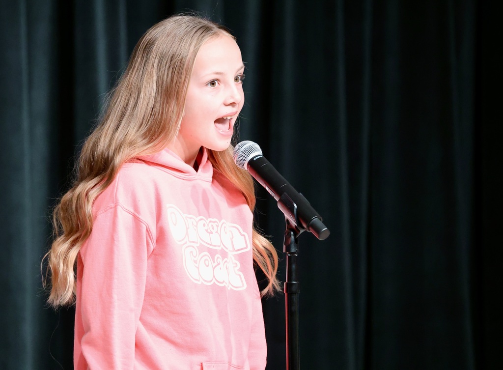 A student singing or talking into a mic. 