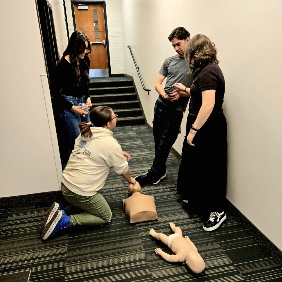 4 students prepared to practice CPR and AED