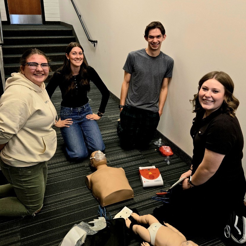4 students smiling after successfully completing their CRP/AED run