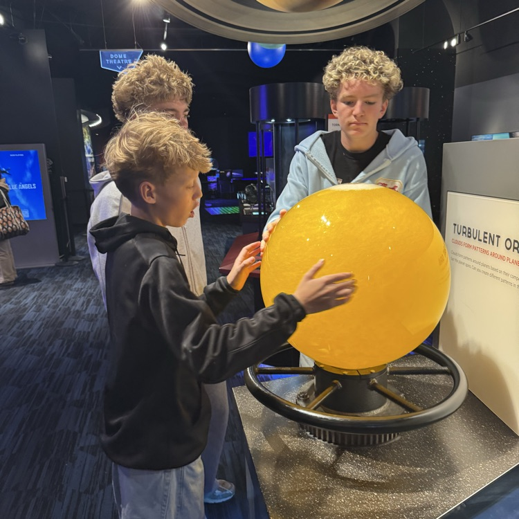 students exploring the planetarium exhibits