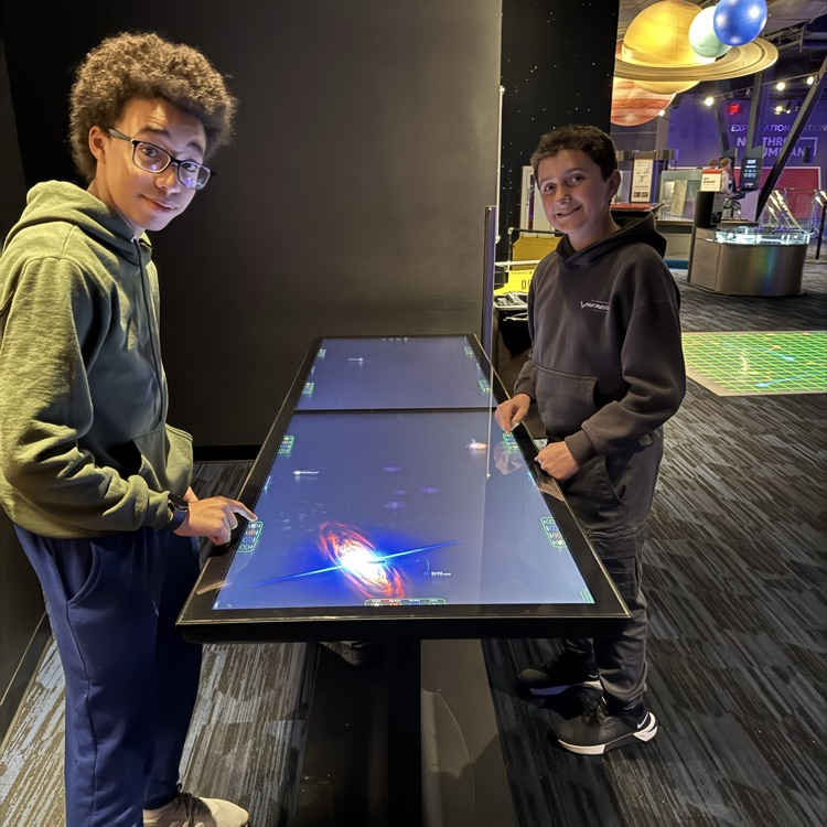 students exploring the planetarium exhibits