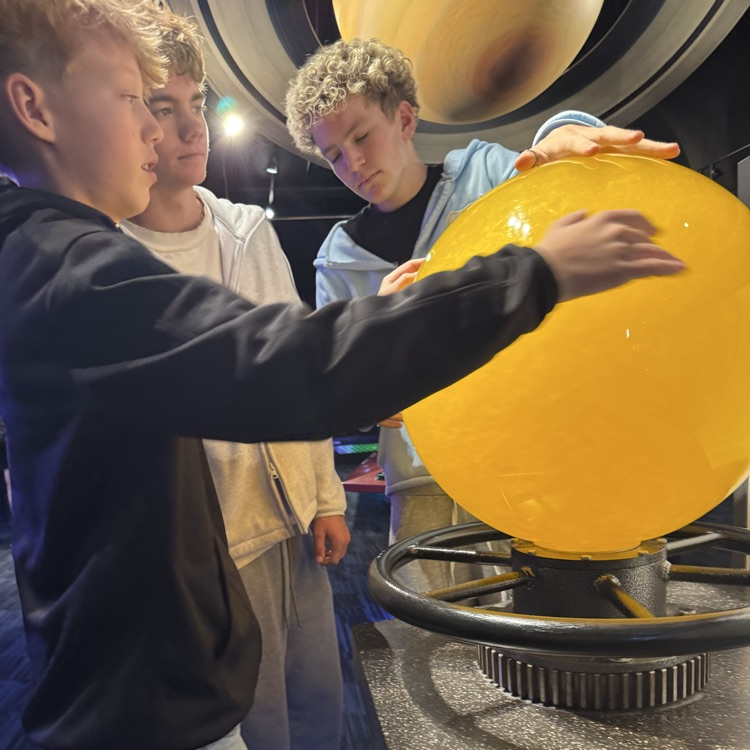students exploring the planetarium exhibits