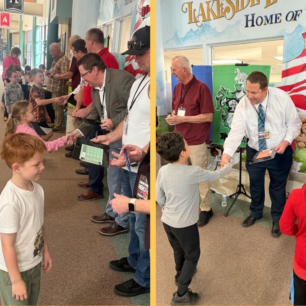 Students shaking hands with adult volunteers in the Amazing Shake Competition.