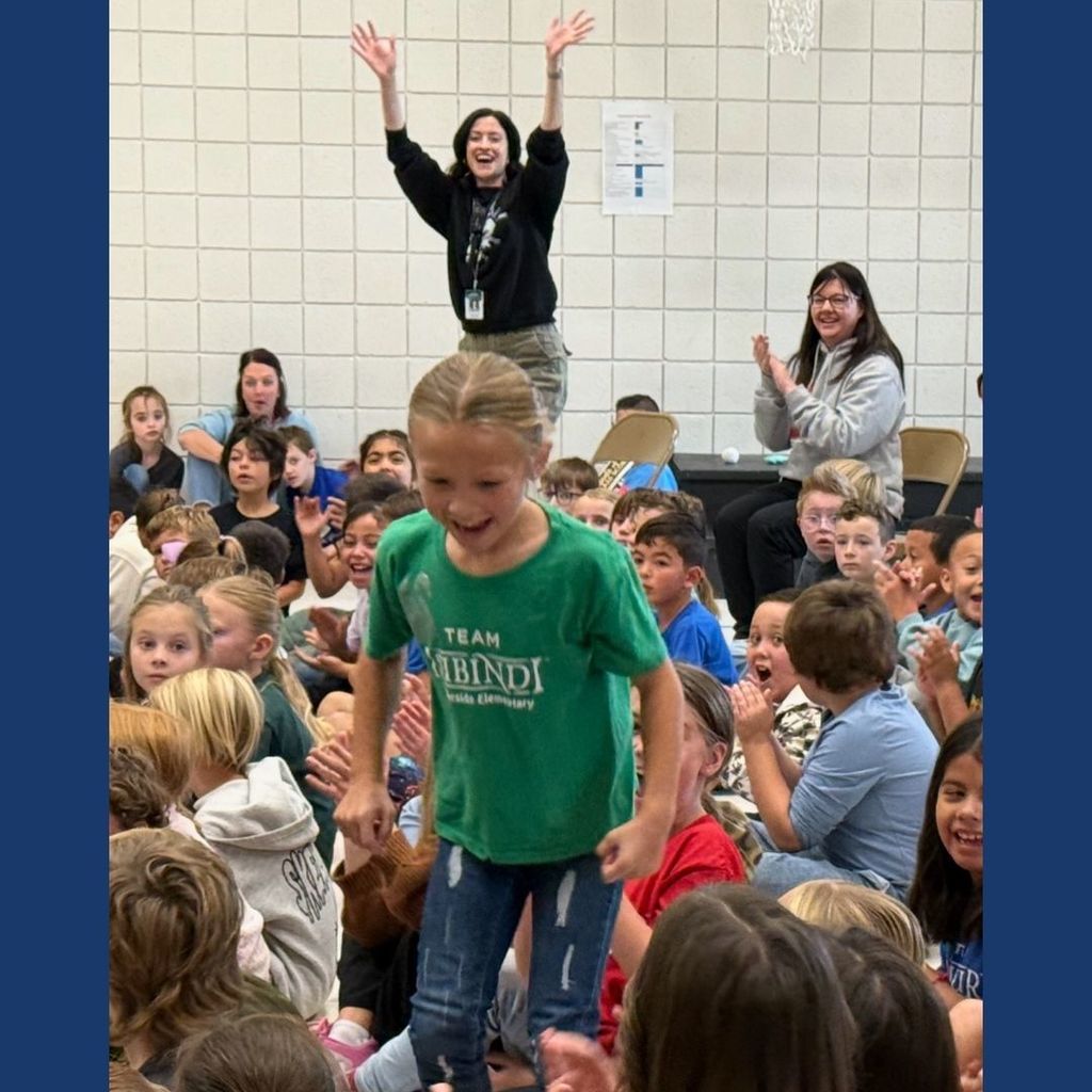 A teachers cheers for a student that has just won the Amazing Shake.