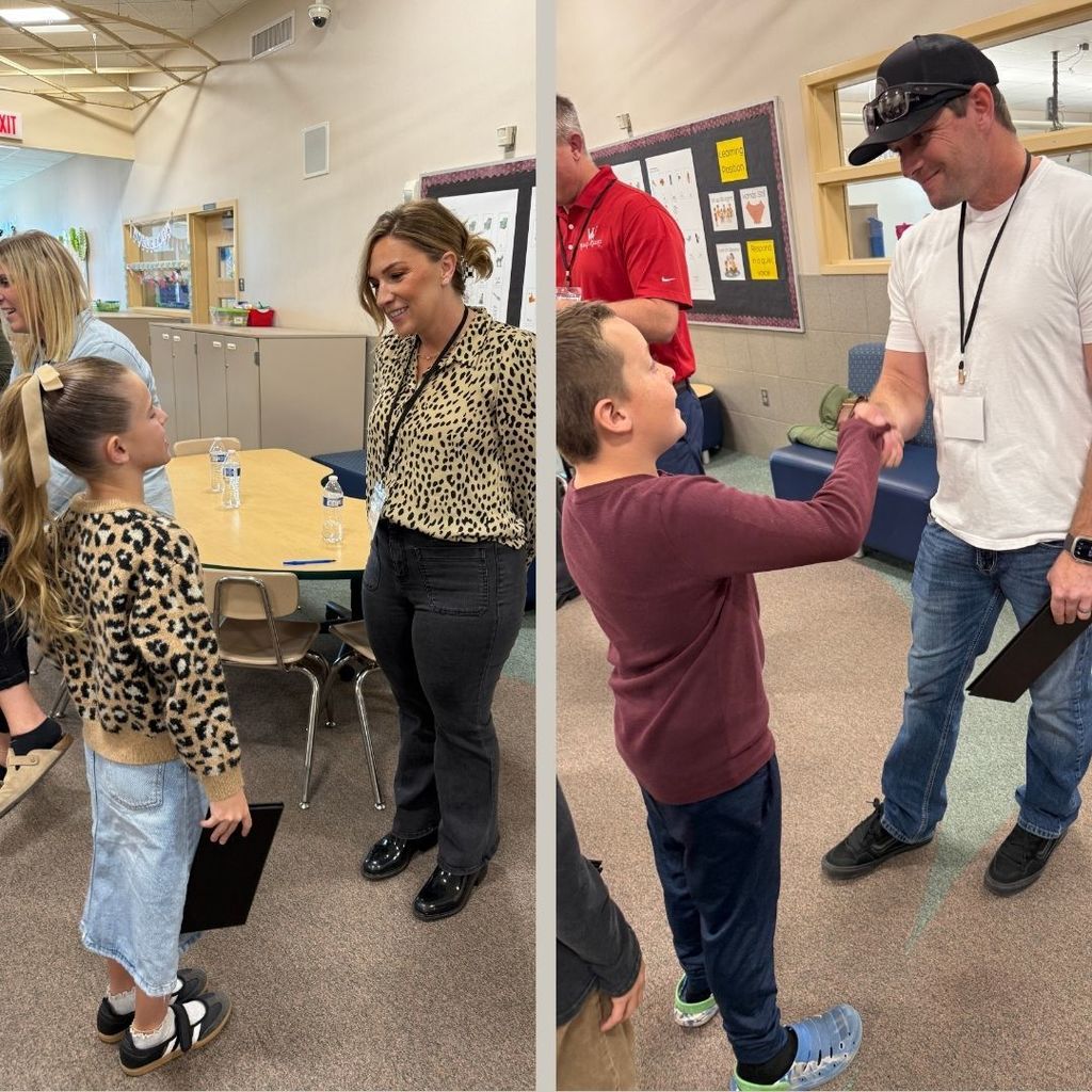 Students shaking hands with adult volunteers in the Amazing Shake Competition.