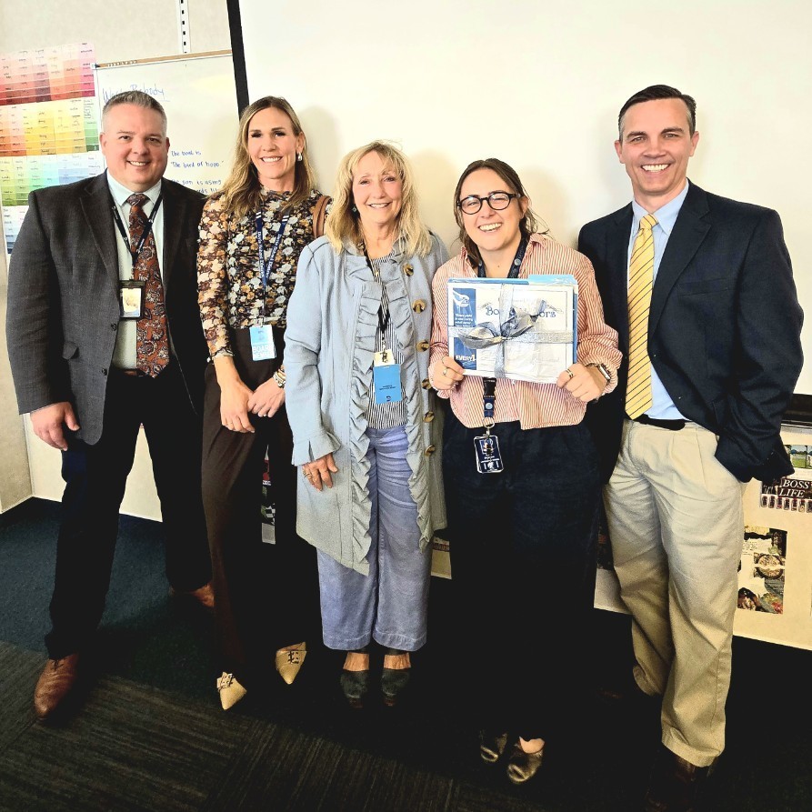 Mrs. Francom holding her award along side Principal Jackman, Superintendent Linford, and school board members