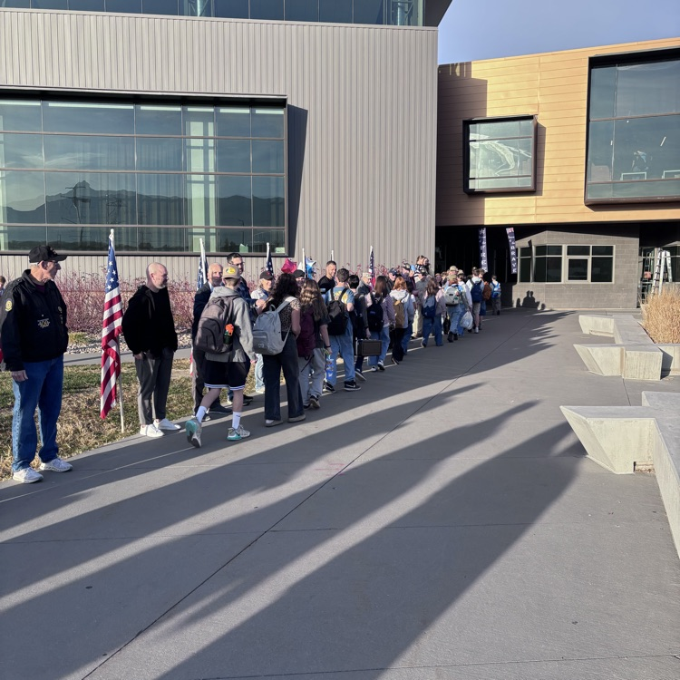 students greeting veterans