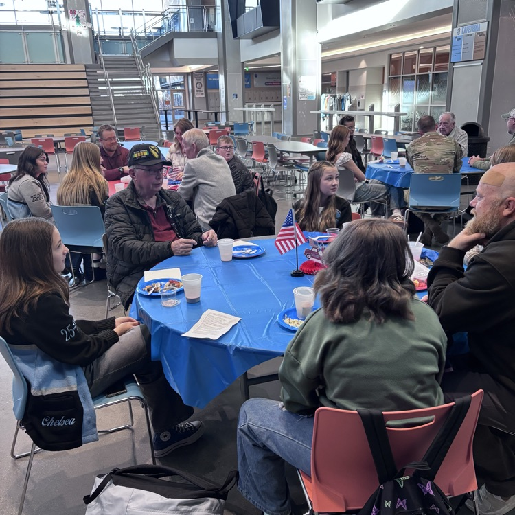 students greeting veterans