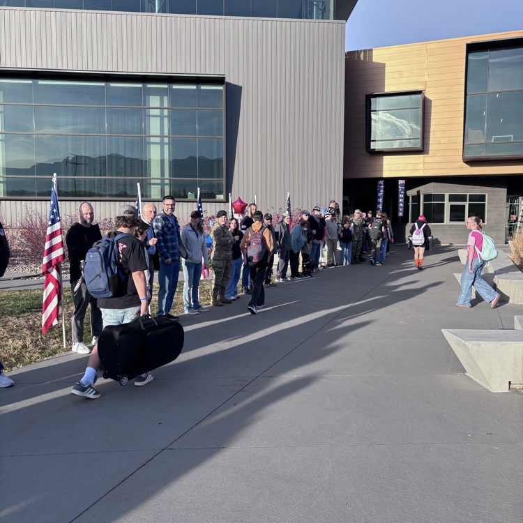 students greeting veterans