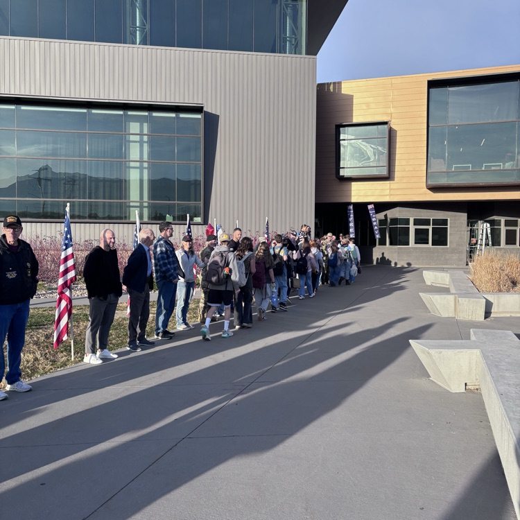 students greeting veterans