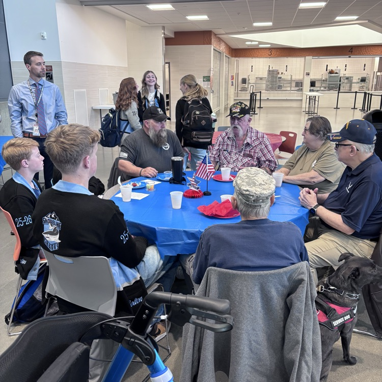 students greeting veterans