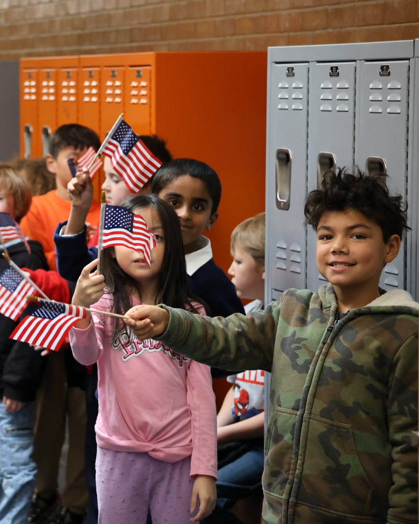 Davis School District students wave flags in the halls on Veterans Day. 