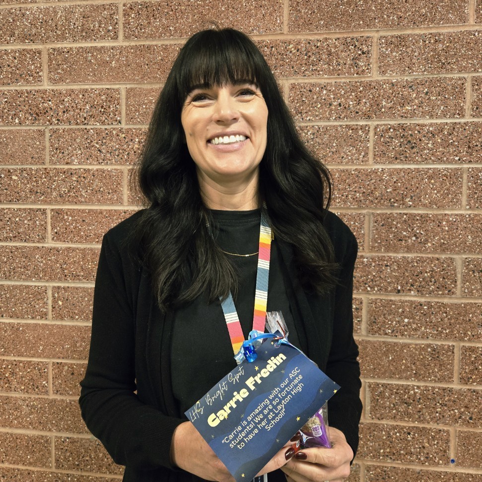 Mrs. Fredin holding her Bright Spot Award