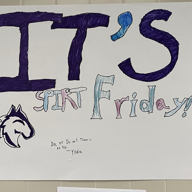 A poster is displayed on the school wall with the words “”It’s Spirit Friday!” A school logo style of the Wolf mascot is also displayed. 