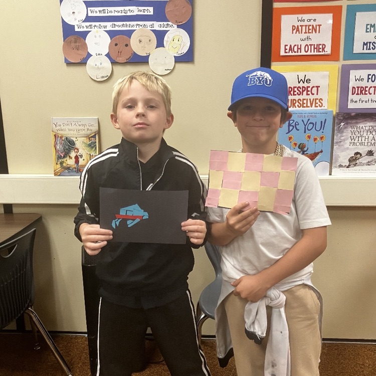 students showing mosaic art projects