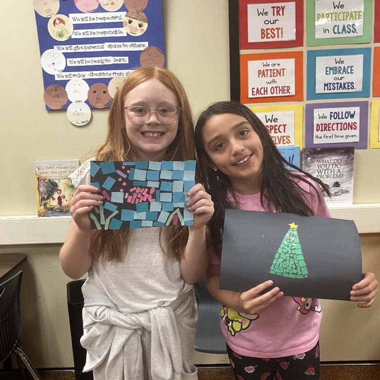 students showing mosaic art projects