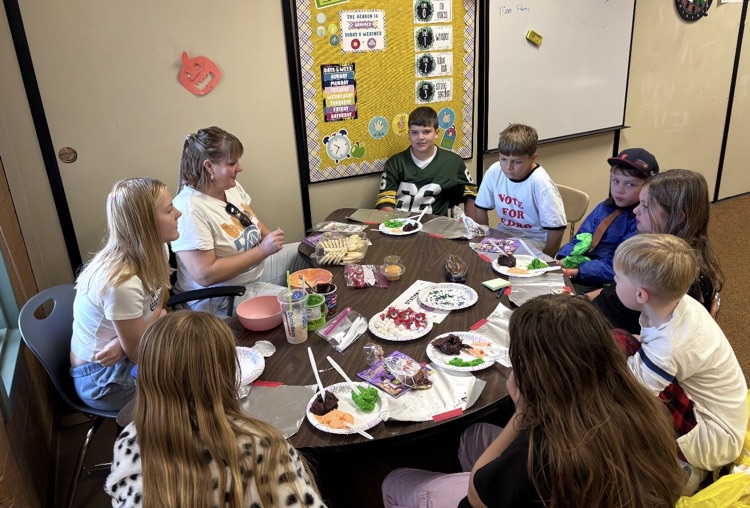 students with Halloween party treats