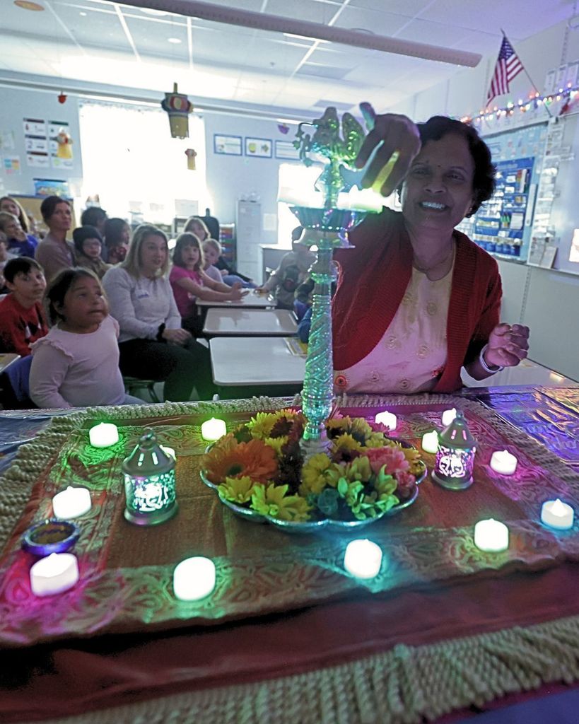 A class learning about Diwali and there are small candles everywhere. 