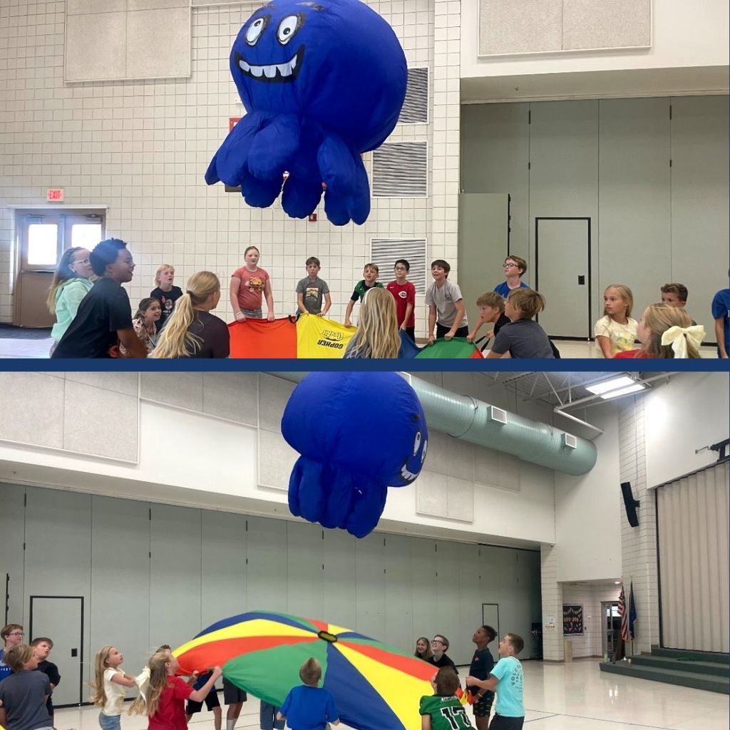 Students in PE playing with a parachute and a giant octopus.