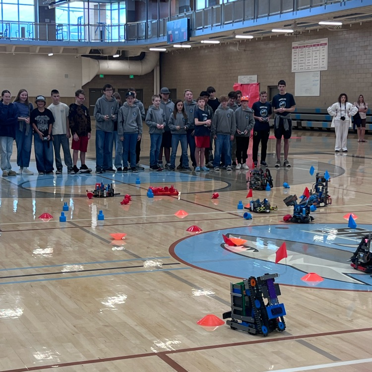 Robotics students competing to gather the most cones for their teams.