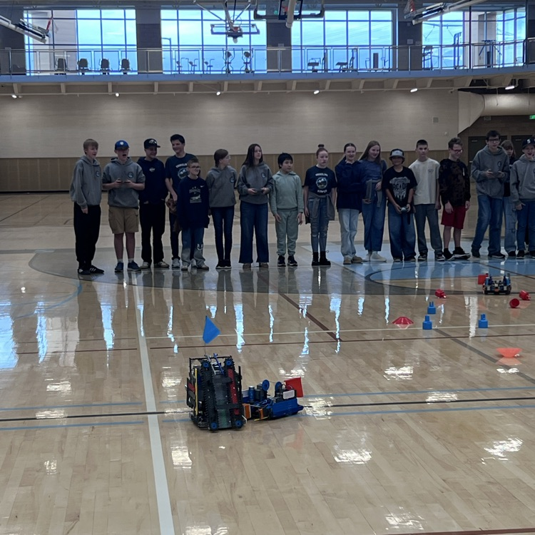 Robotics students competing to gather the most cones for their teams.