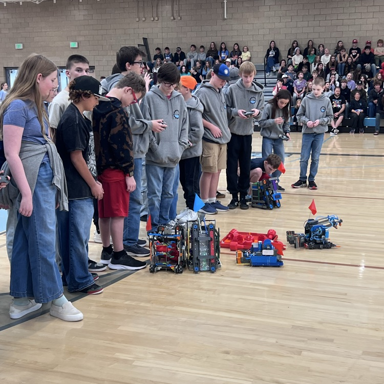 Robotics students competing to gather the most cones for their teams.