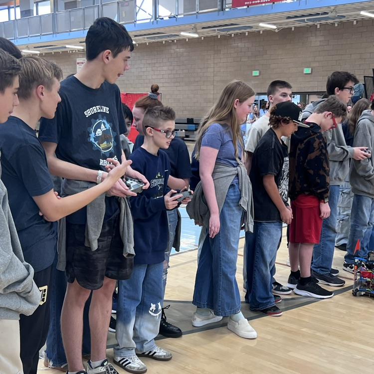 Robotics students competing to gather the most cones for their teams.