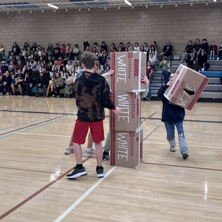 Robotics students race to stack their boxes first.