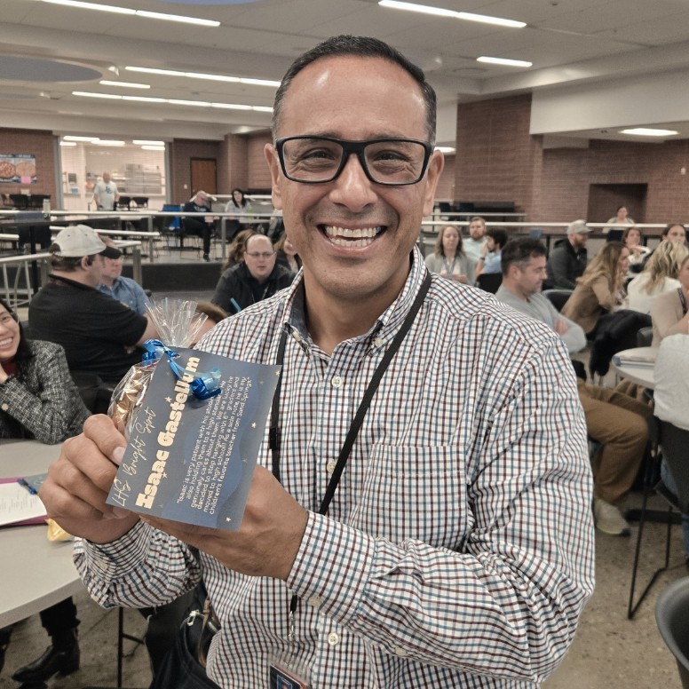 Mr. Gastellum holding his Bright Spot Award and smiling for the camera