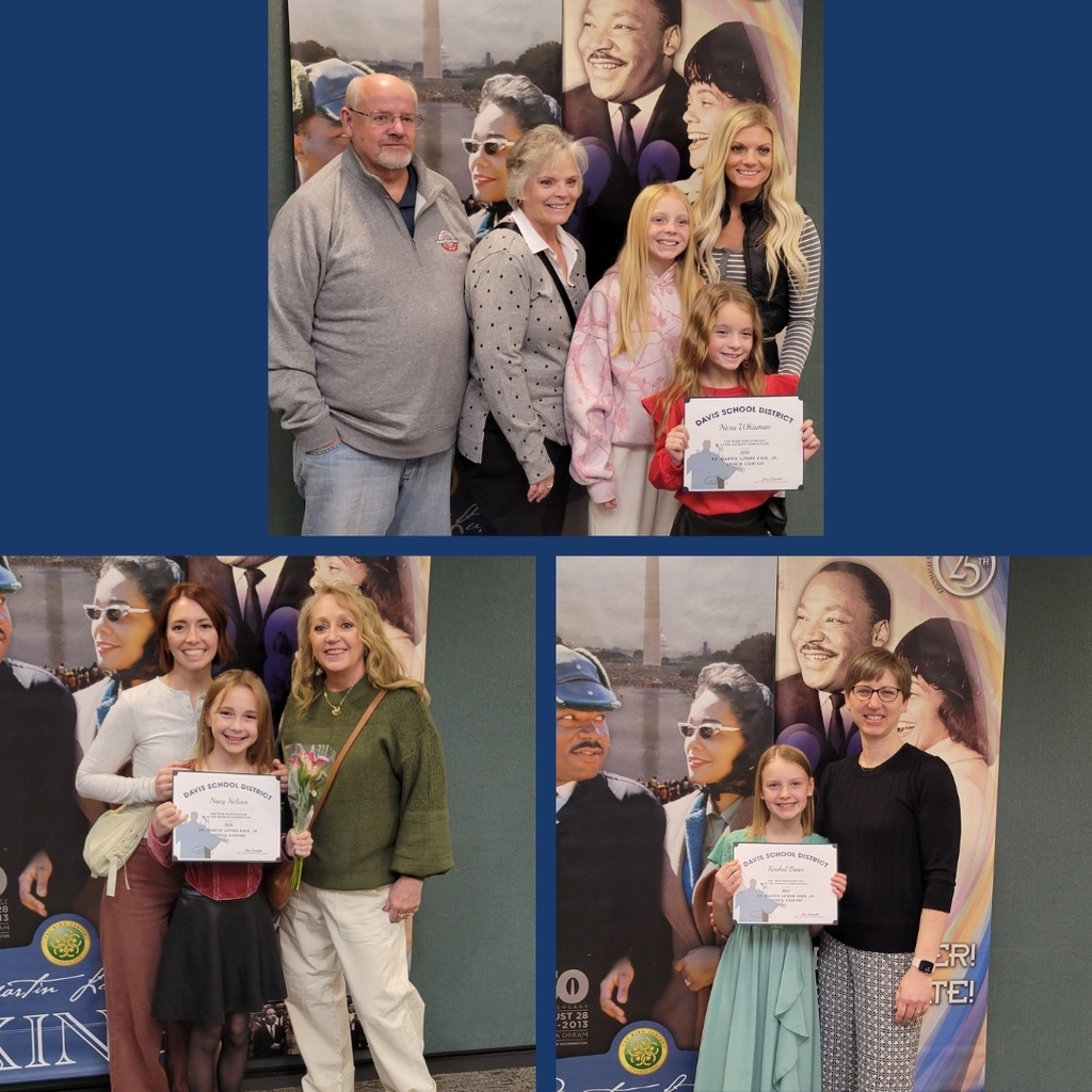 Students with their families standing in front of MLK backdrop.