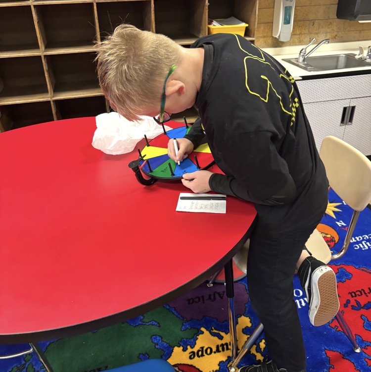 student writing prizes on wheel