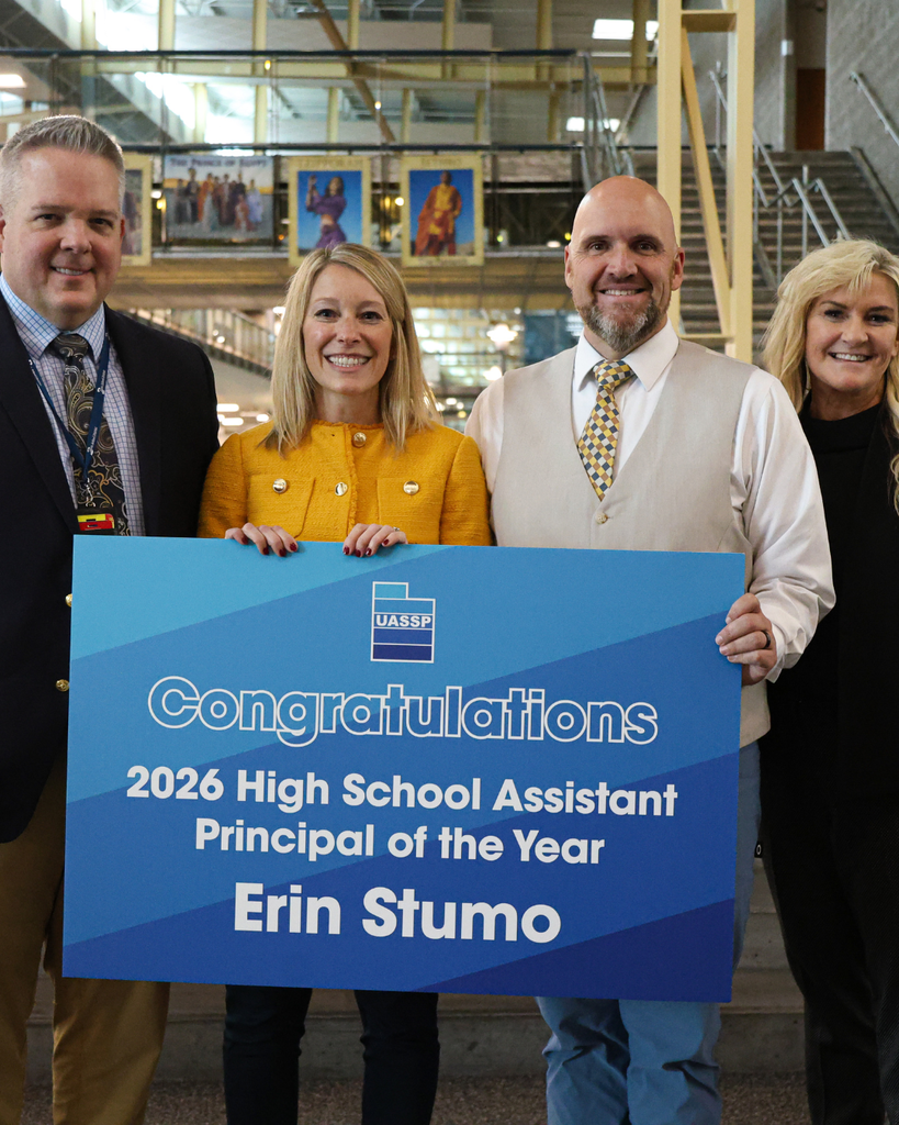 A photo of Syracuse High Assistant Principal Erin Stumo, Davis School District Superintendent Dr. Dan Linford, Syracuse High Principal Brad Chapple and a member of the UASSP. Erin is holding a sign that says: "Congratulations 2026 High School Assistant Principal of the Year Erin Stumo."