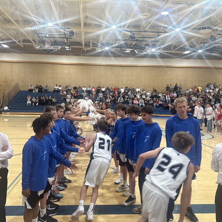 FFJH basketball player running through tunnel