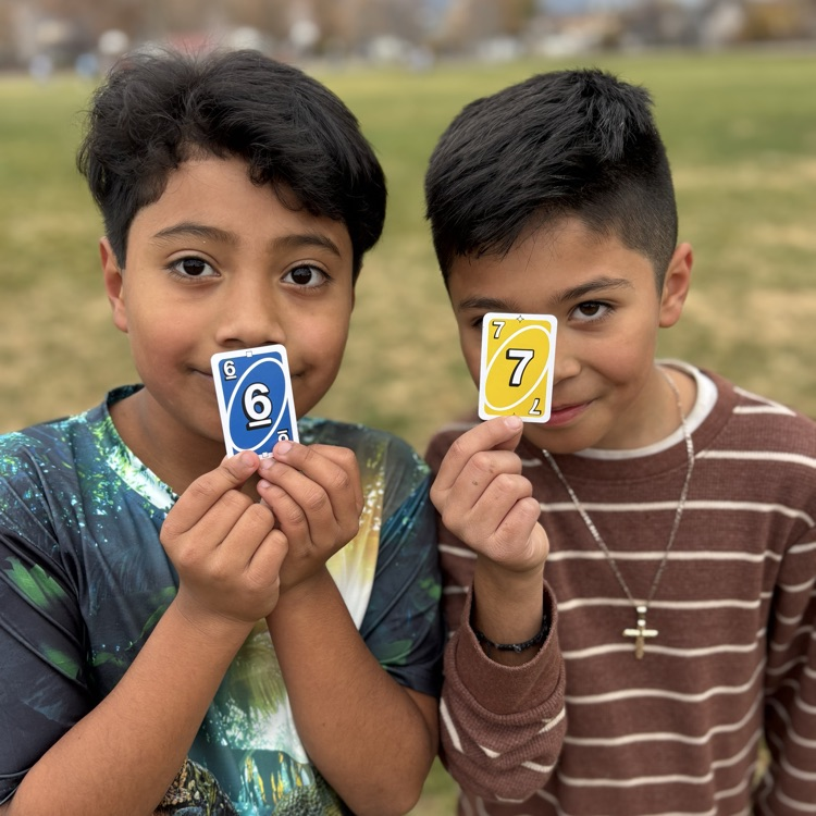 Students holding 6-7 uno cards!