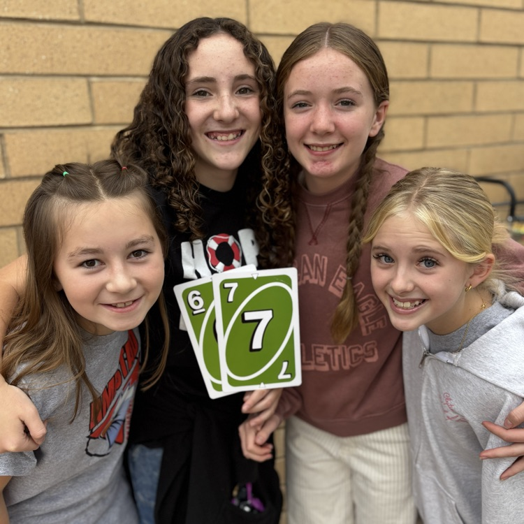 Students holding 6-7 uno cards!