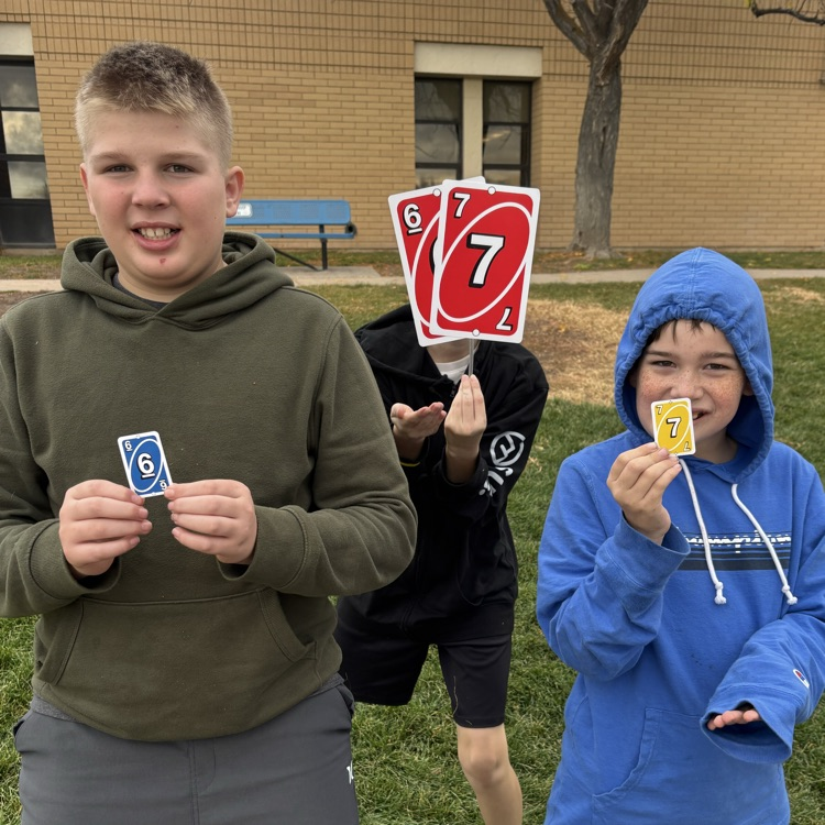 Students holding 6-7 uno cards!