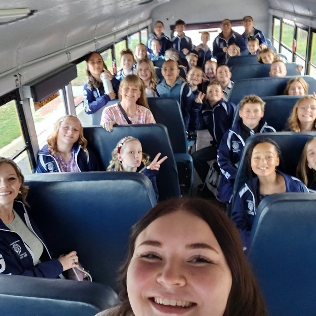 Student Council members posing for a picture on a bus.