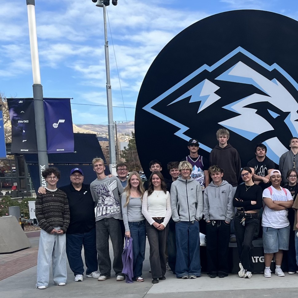 Lancer students in front of the mammoth sign at the delta center for the utah jazz marketing event