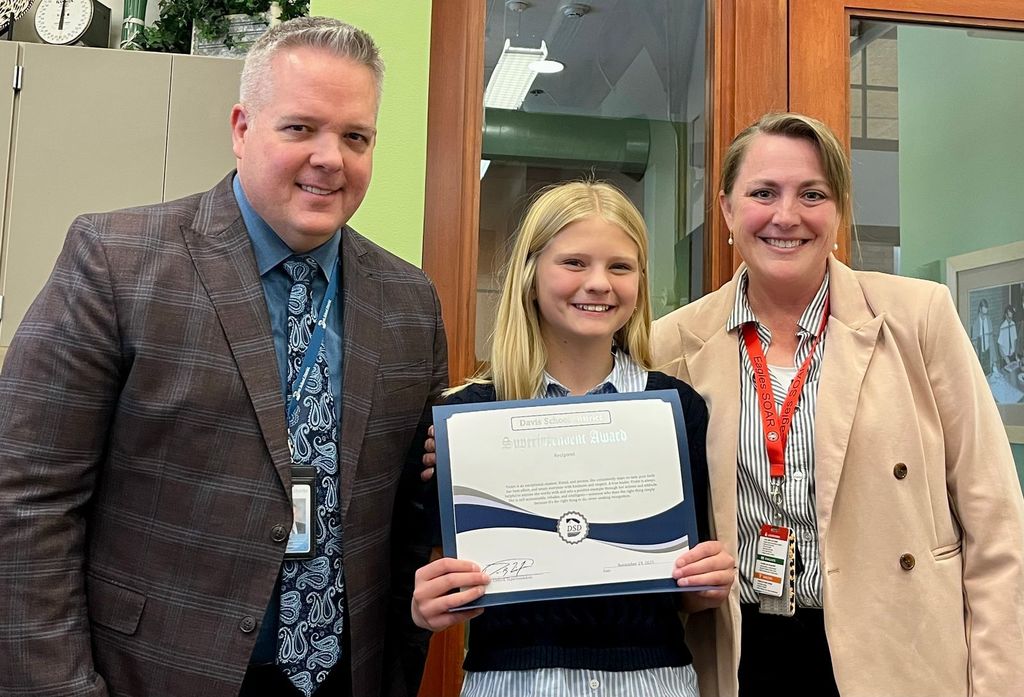 Superintendent and Principal with student holding a certificate for Soup with the Super.