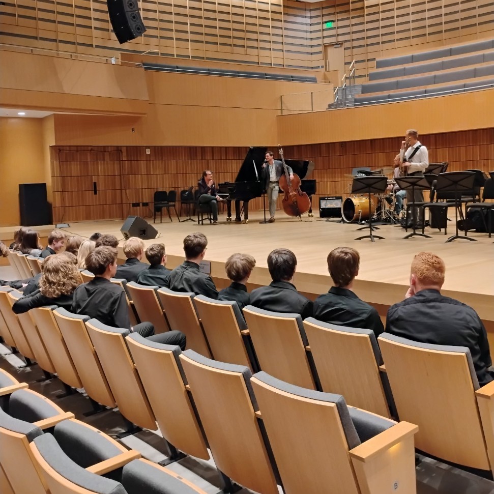 jazz Band students watching musicians on the stage