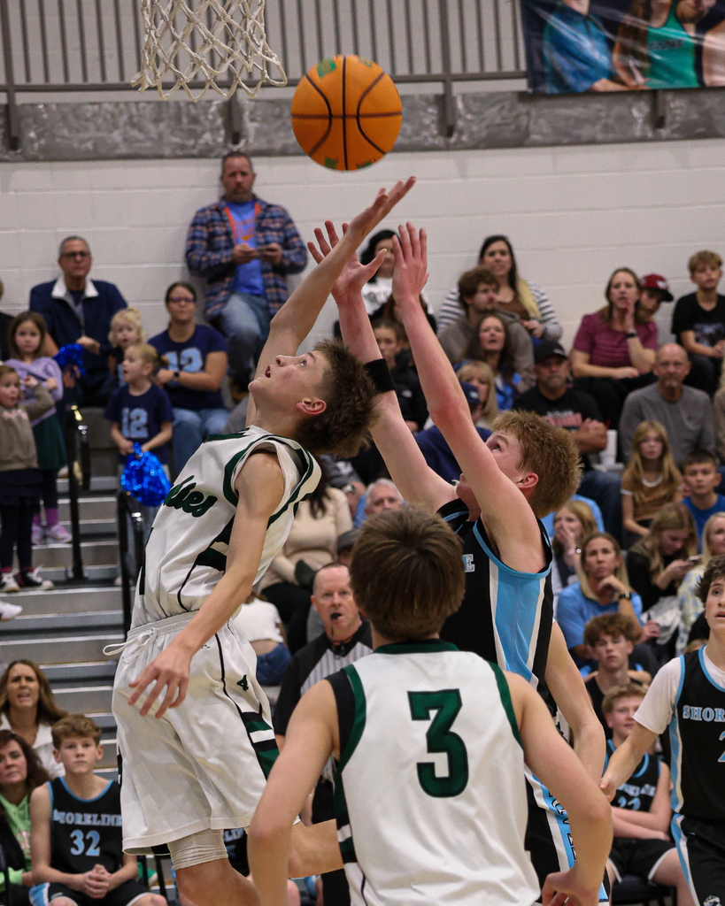 A Farmington Junior High player swats at the basketball at the Davis School District Boys Basketball Championship Game. 